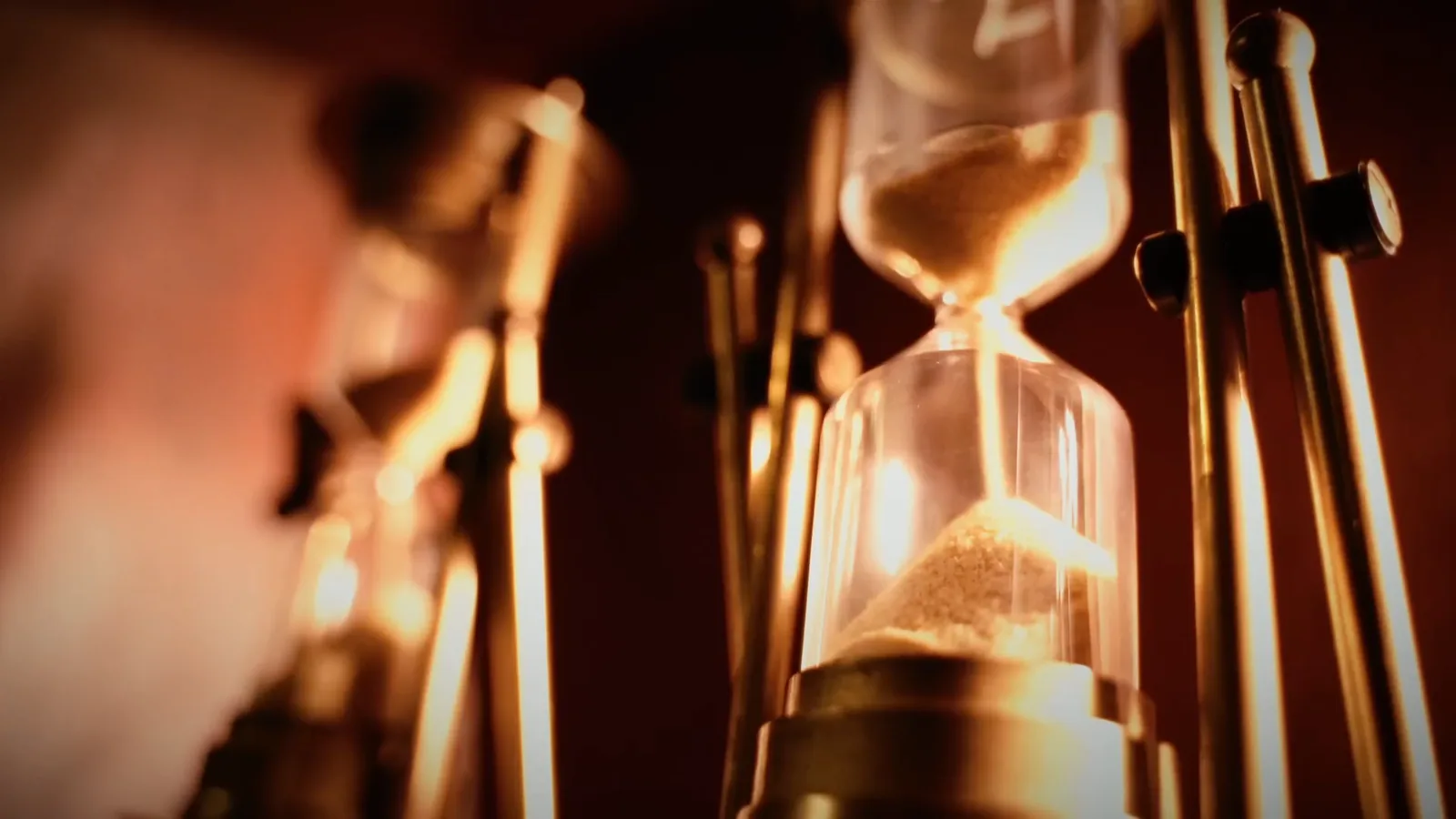 An hourglass running down among brass instruments in Entombed