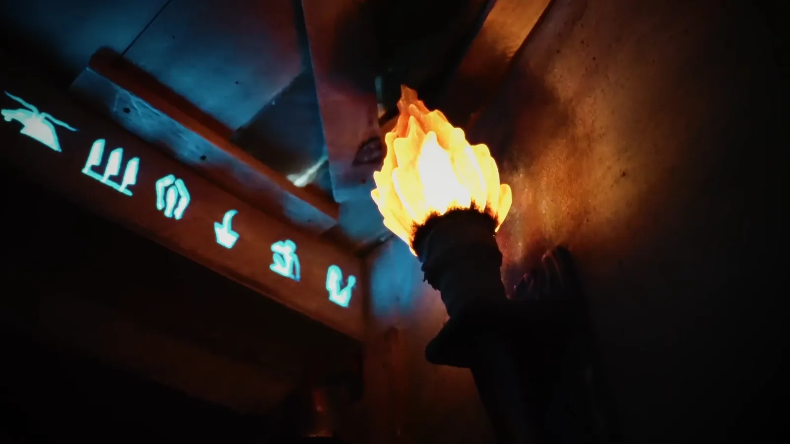 A burning wall torch beside glowing blue hieroglyphs in Entombed